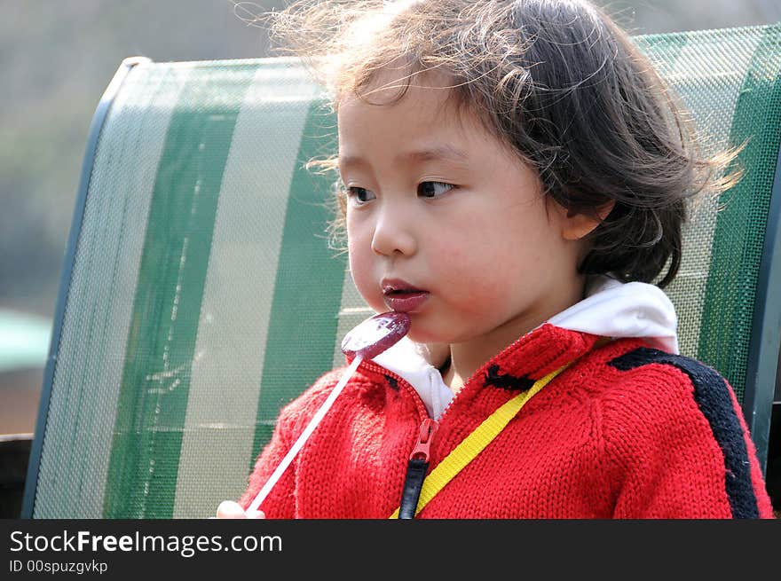 A beautiful girl in red，and eat the sugar. A beautiful girl in red，and eat the sugar