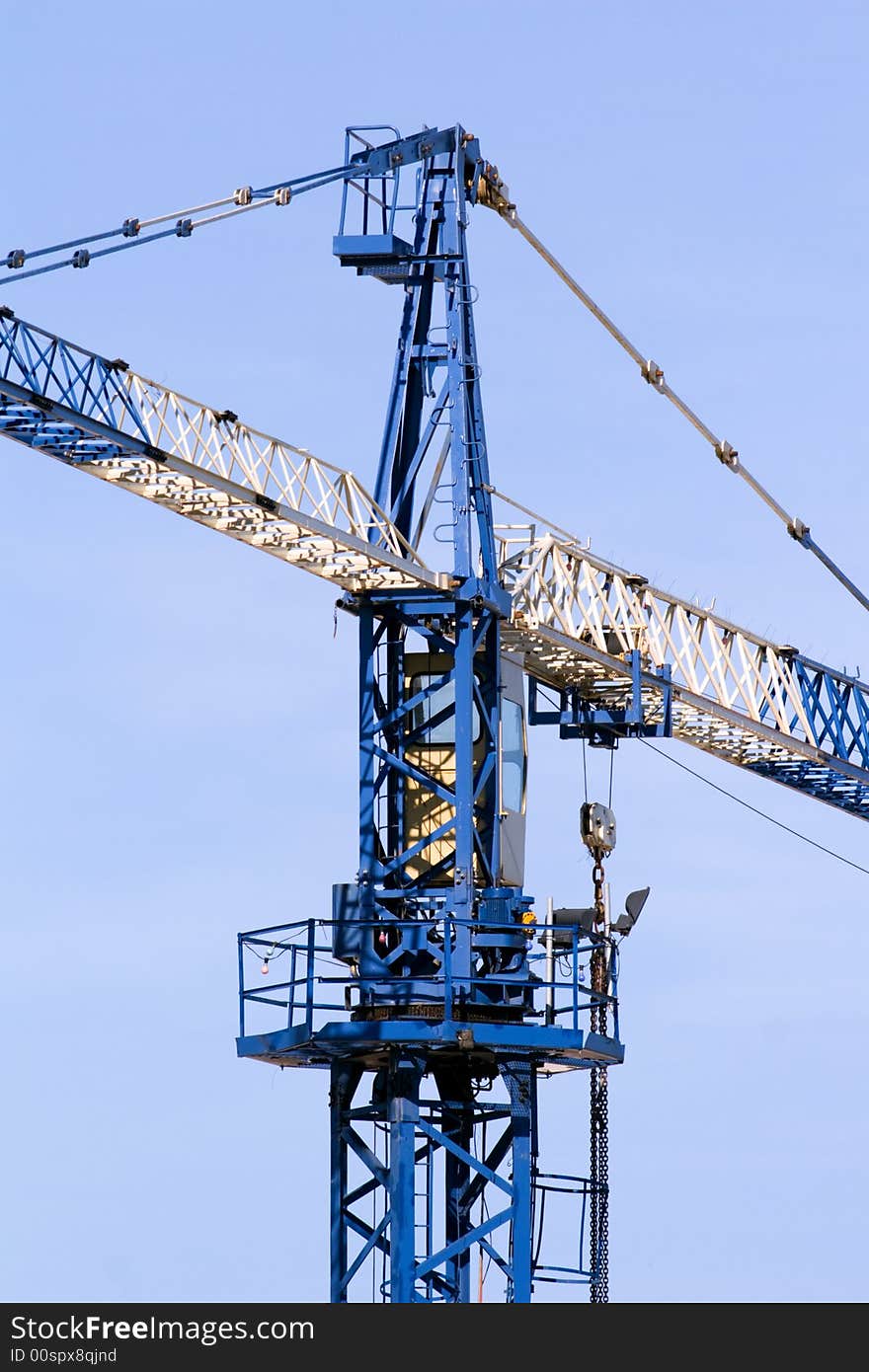 A blue and white crane at a construction site