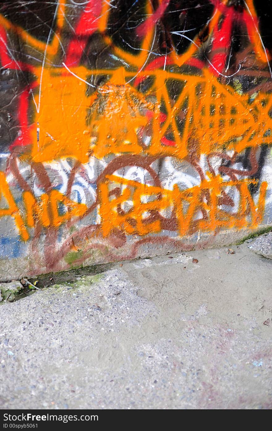 A portrait shot of a wall covered in Orange graffiti. A portrait shot of a wall covered in Orange graffiti