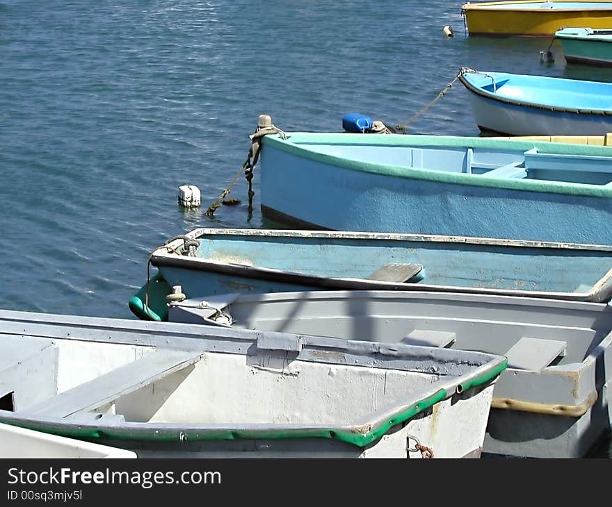 Row boats sitting in the Mediterranean ocean