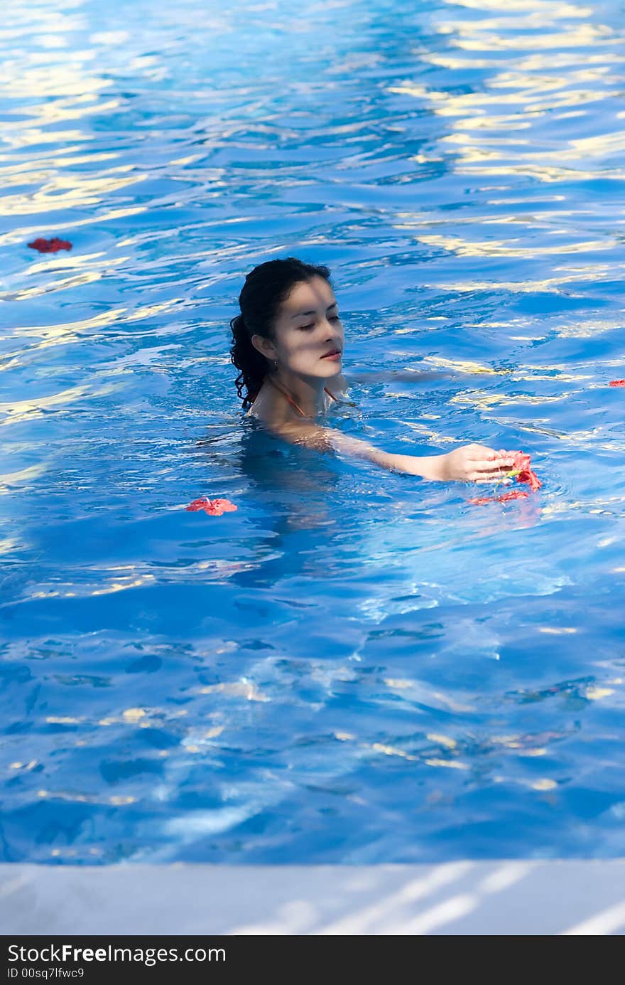 Blue water red flowers floating. Blue water red flowers floating