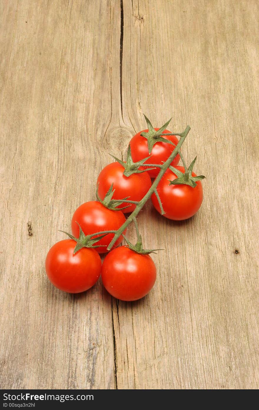 Vine tomatoes on rustic wood. Vine tomatoes on rustic wood