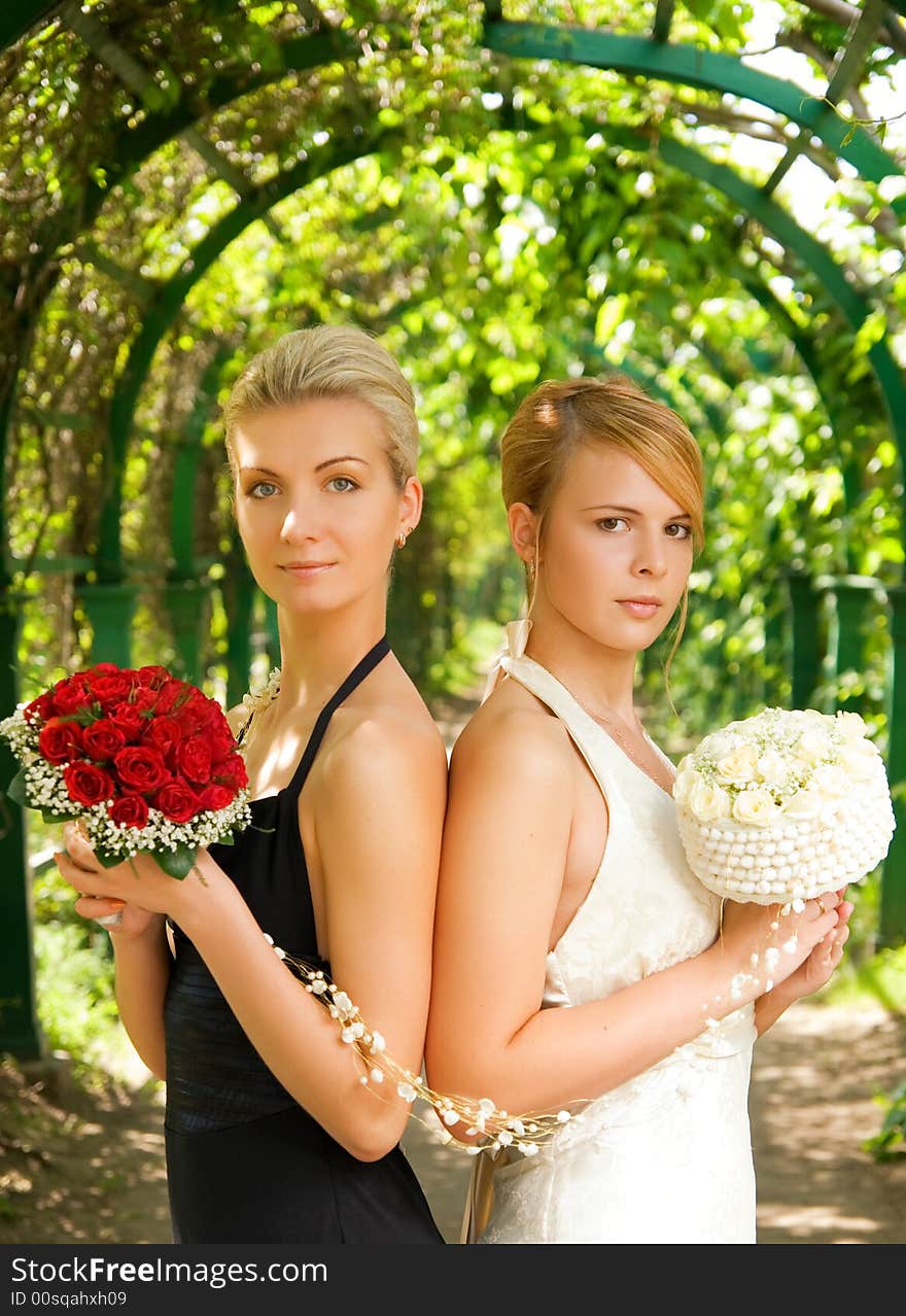 Two girls with a flowers in green alley