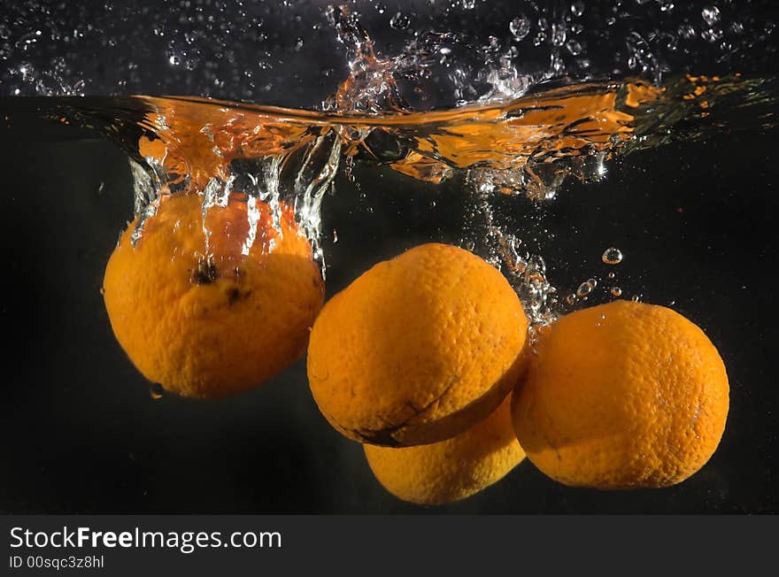 Tangerines falling in water