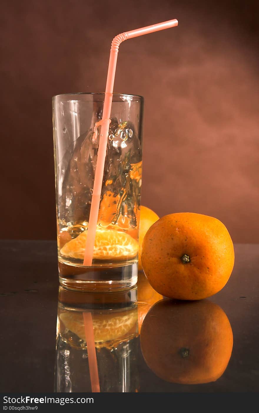 Glass of a drink with a tangerine