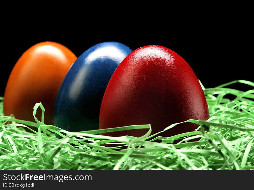 3 eggs are standing on the grass