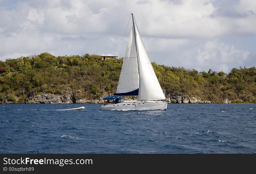 Sailboat and dingy in the west Indies. Sailboat and dingy in the west Indies.