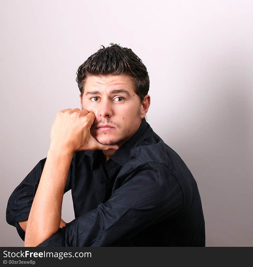 Male model in studio against white wall. Male model in studio against white wall