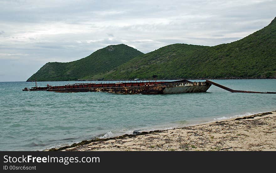 Abandoned Steel Barge on a Beach in the Caribbean. Abandoned Steel Barge on a Beach in the Caribbean