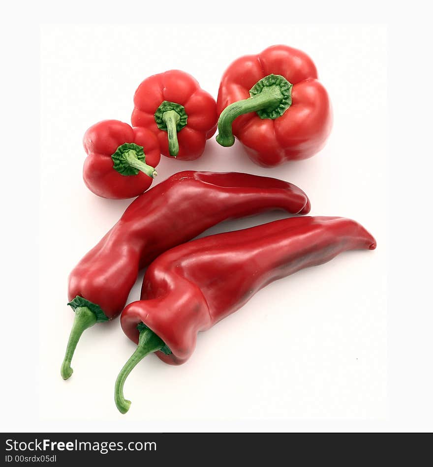 Different kinds of red peppers isolated on white.