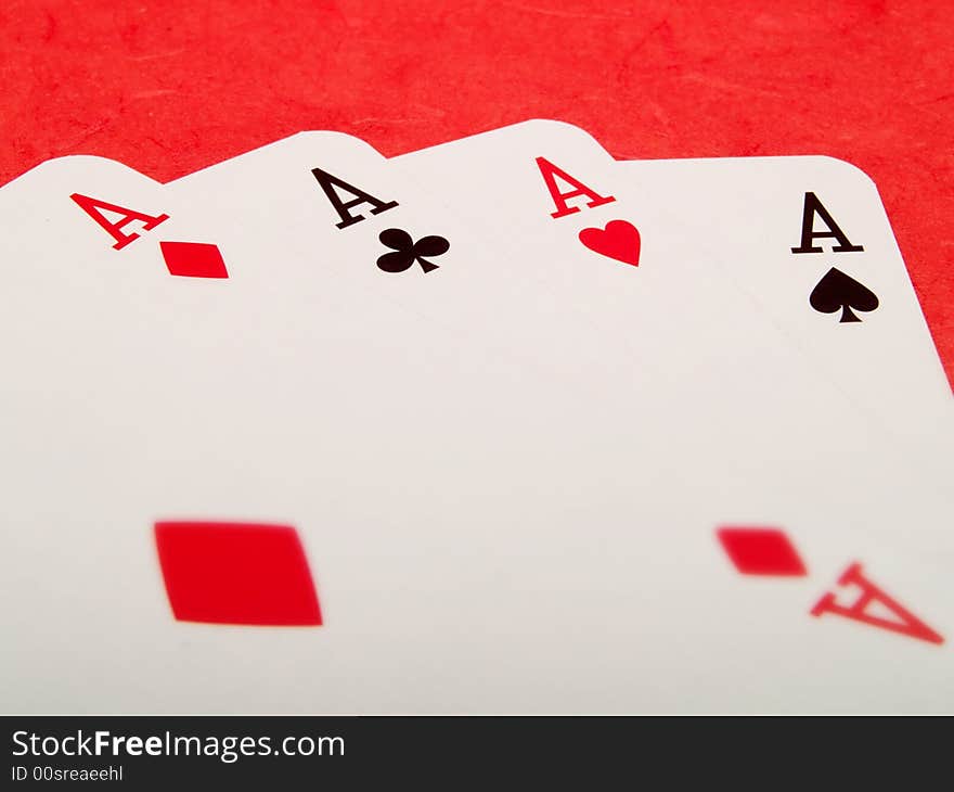 Four aces cards on a red background