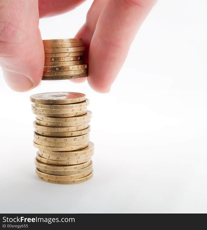 Pile of coins and hand on a white background. Pile of coins and hand on a white background