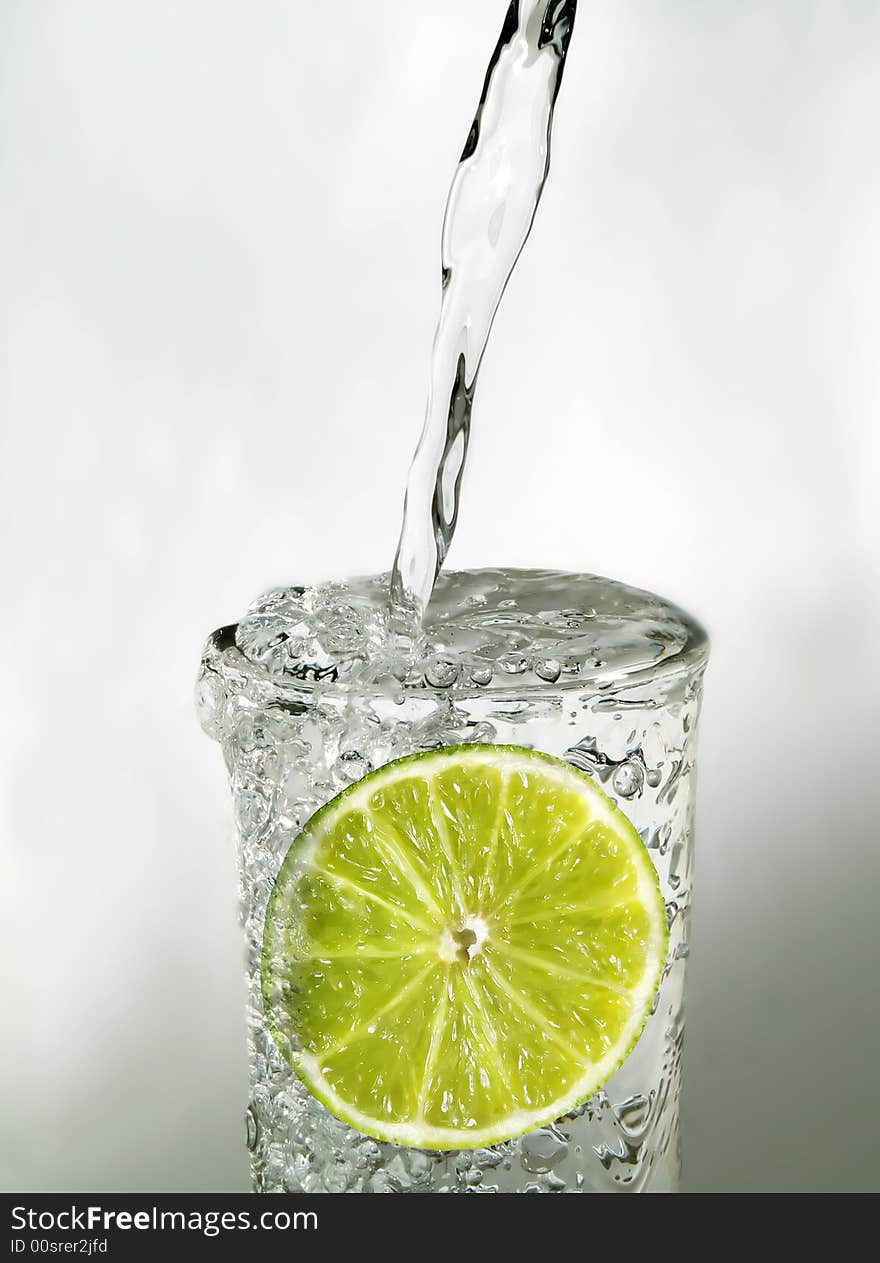 Lime slice in a glass of water. Lime slice in a glass of water