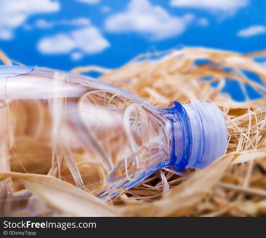 Bottle of mineral water over a blue sky. Bottle of mineral water over a blue sky