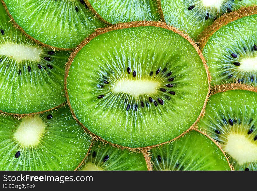 Ripe green kiwi slices background