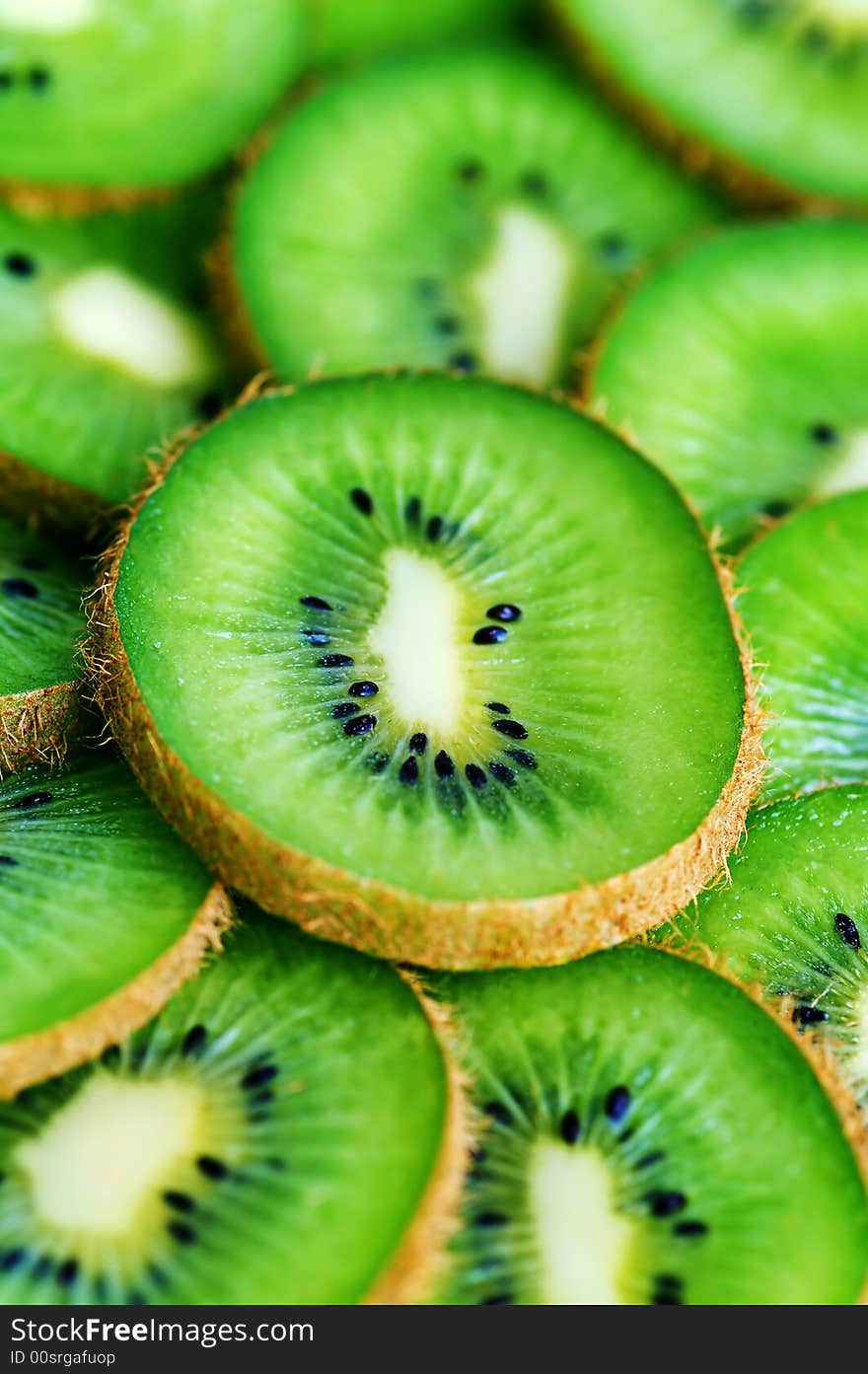 Green ripe kiwi slices background