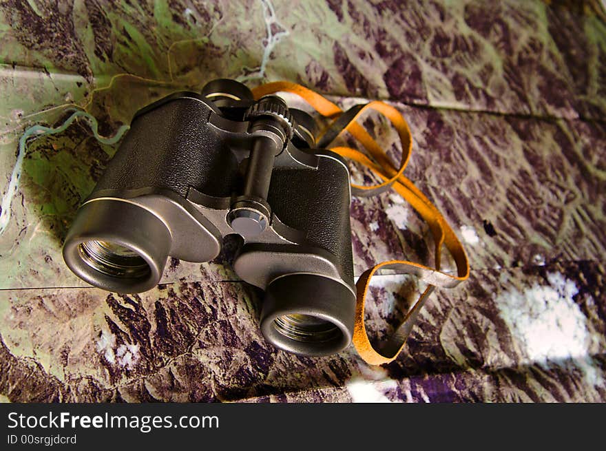 Black binoculars on photo map. Black binoculars on photo map