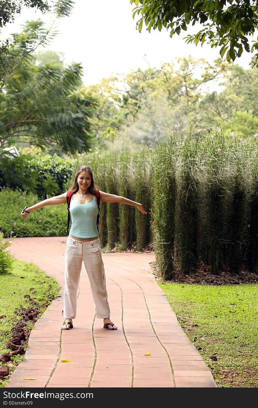 Happy woman on the garden's road. Happy woman on the garden's road