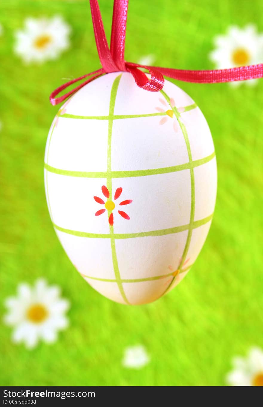 Pastel and colored Easter egg on green