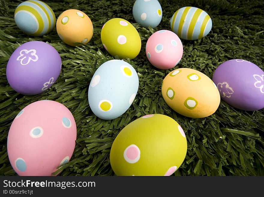 A group of brightly colored easter eggs on green grass. A group of brightly colored easter eggs on green grass