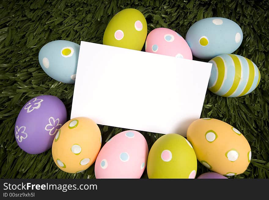 A white notecard surrounded by brightly colored Easter eggs, insert message or design. A white notecard surrounded by brightly colored Easter eggs, insert message or design