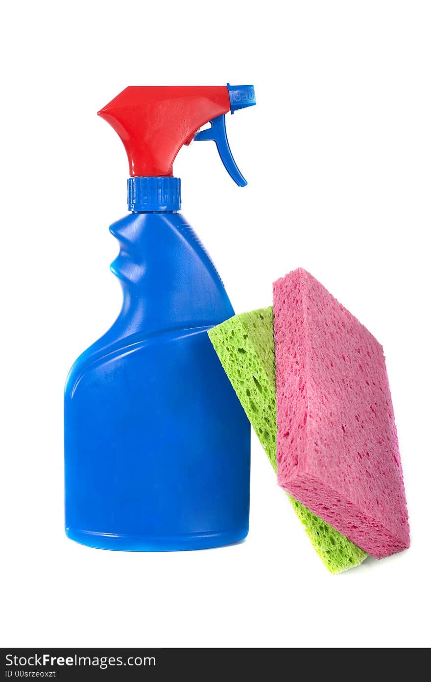A red and blue blank spray bottle with a multicolor sponges, spring cleaning etc with copy space. A red and blue blank spray bottle with a multicolor sponges, spring cleaning etc with copy space
