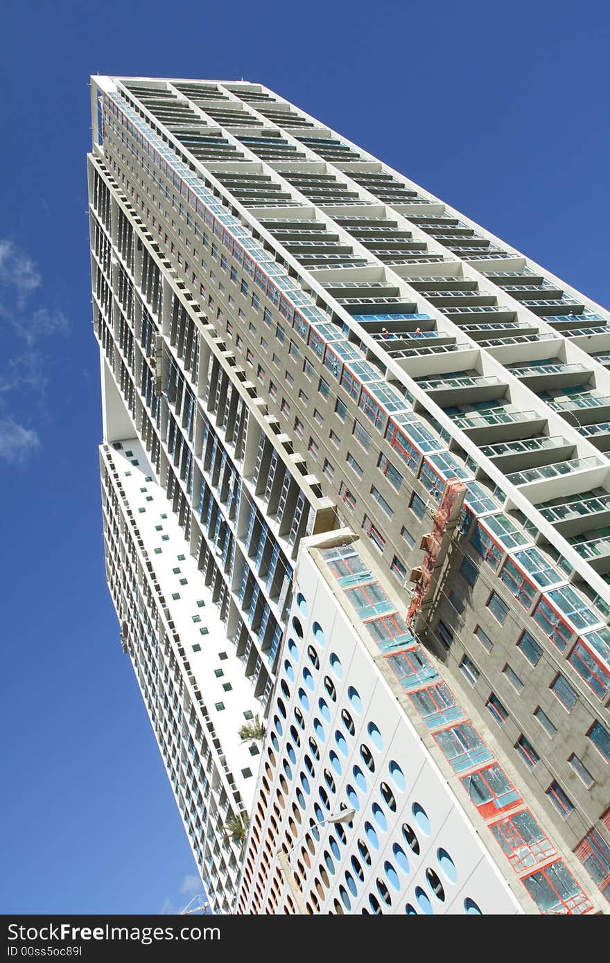 Modern abstract condominium building on a blue sky. Modern abstract condominium building on a blue sky