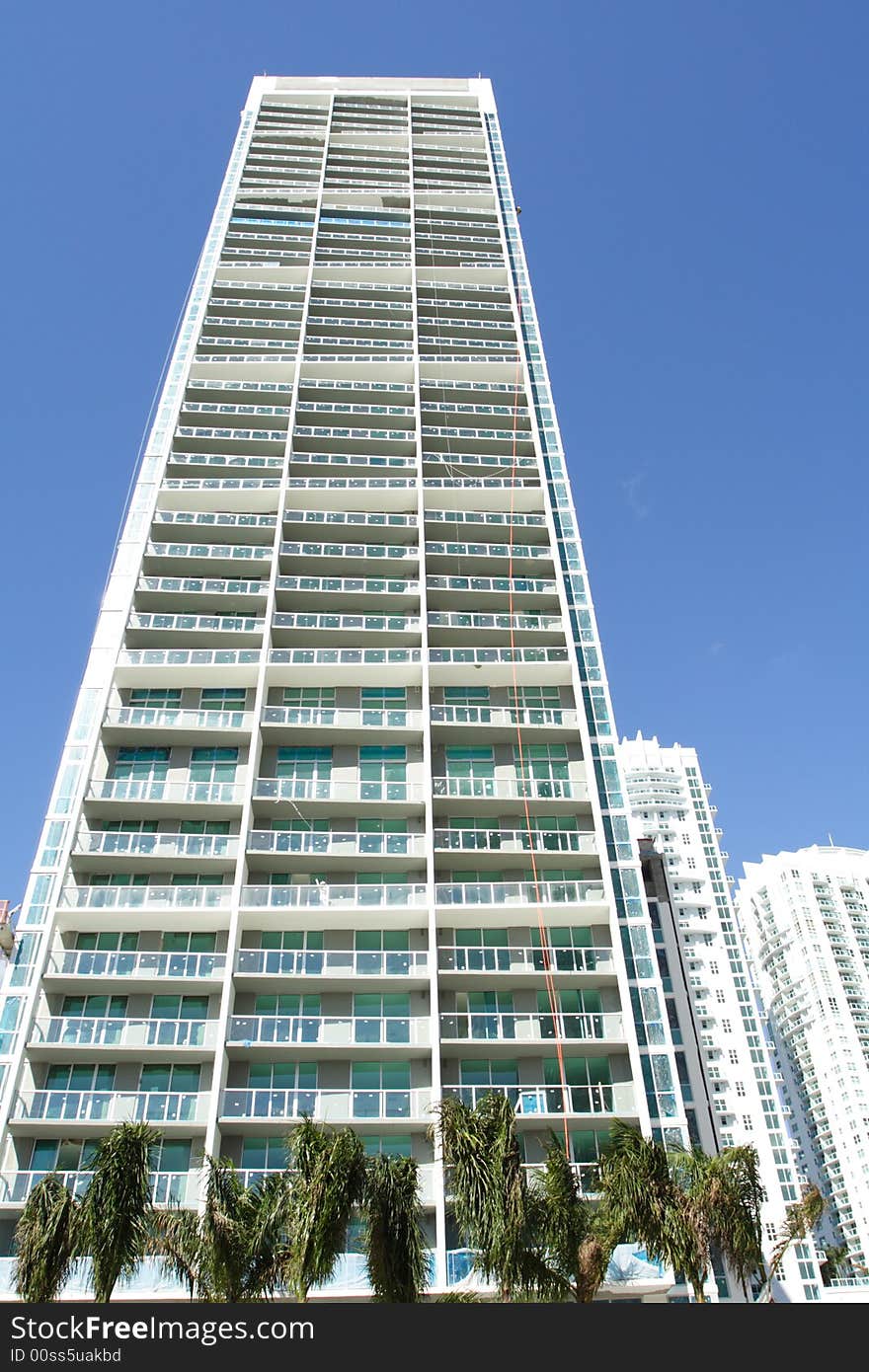 Modern abstract condominium building on a blue sky. Modern abstract condominium building on a blue sky