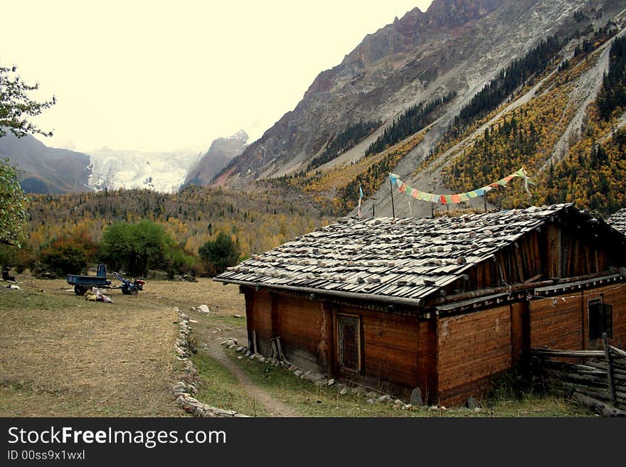 At the entrance of Midui glacier - a tibet house in the autumn valley. At the entrance of Midui glacier - a tibet house in the autumn valley