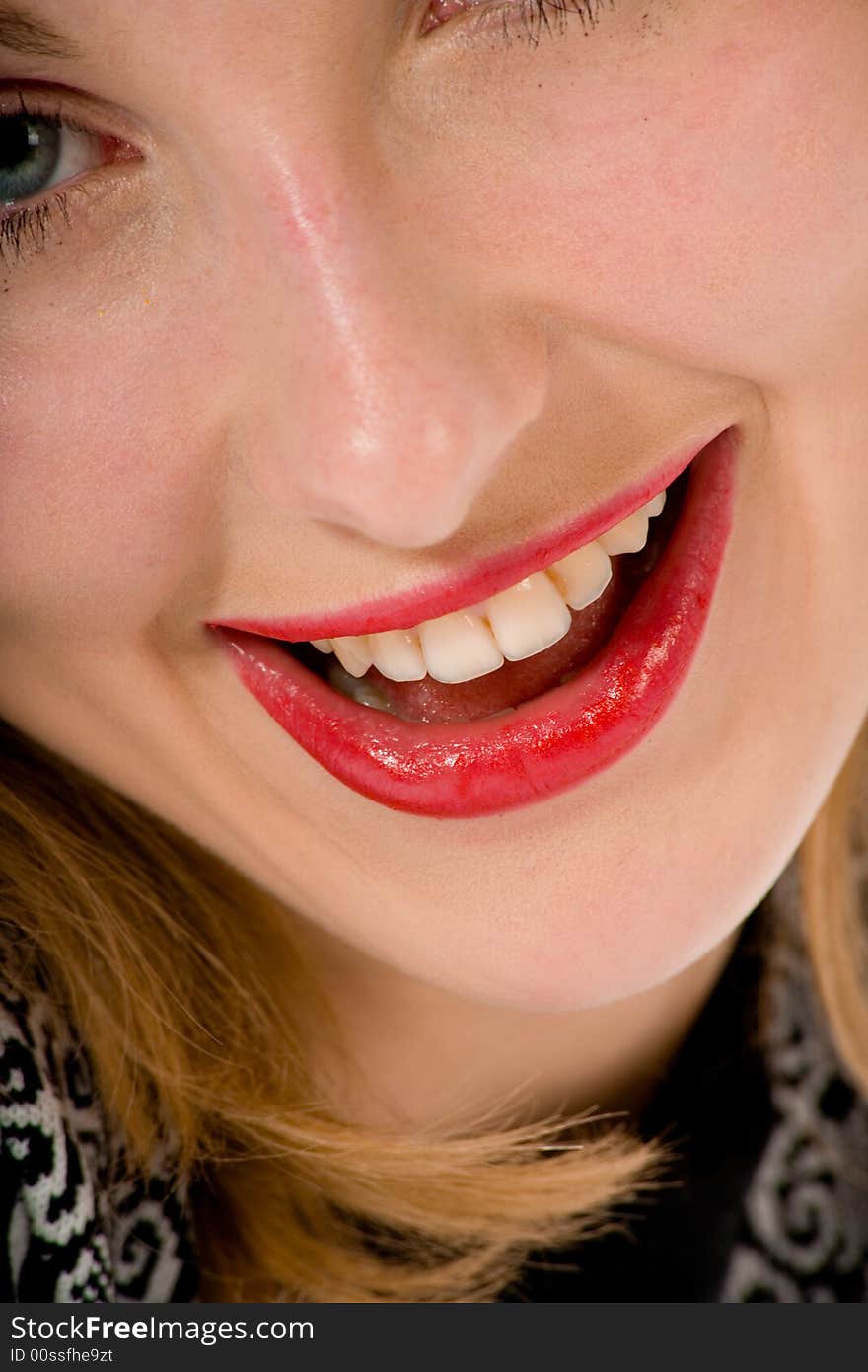 Smile of a beautiful young woman on white background