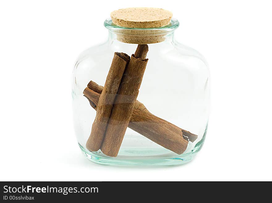 Bark of cinnamon inside closed bottle, isolated on white. Bark of cinnamon inside closed bottle, isolated on white