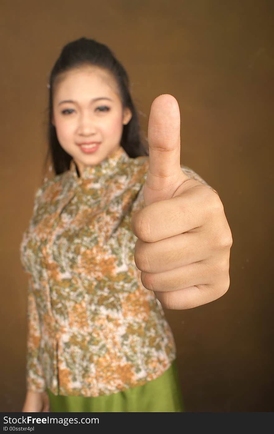 An Asian woman giving thump up