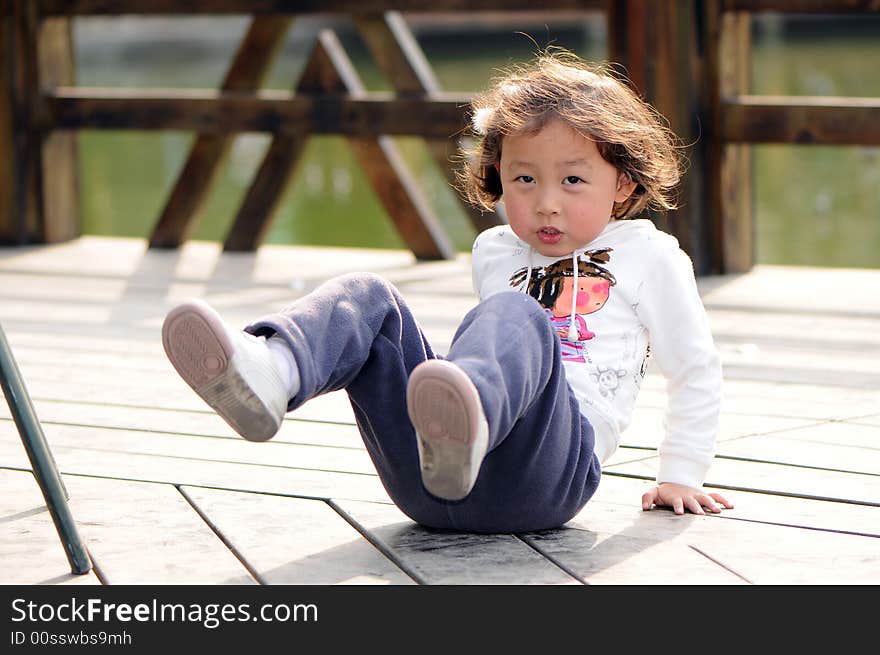 A little lovely girl is sitting.