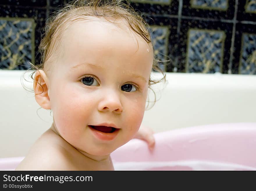 Bathing and smiling baby looking at camera. Bathing and smiling baby looking at camera