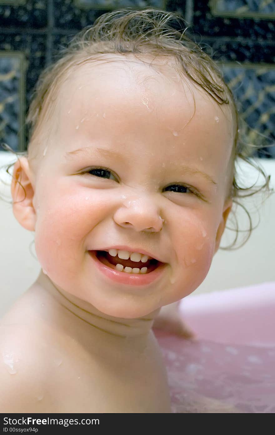 Bathing and smiling baby looking at camera. Bathing and smiling baby looking at camera