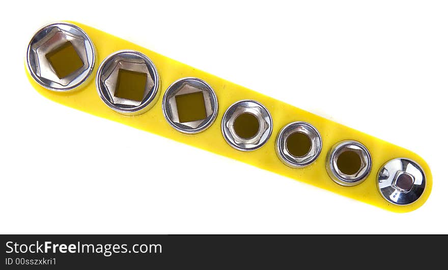 A set of sockets in a yellow holder isolated on white. A set of sockets in a yellow holder isolated on white