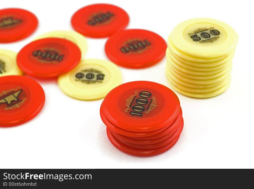 Red and yellow  casino chips isolated on white