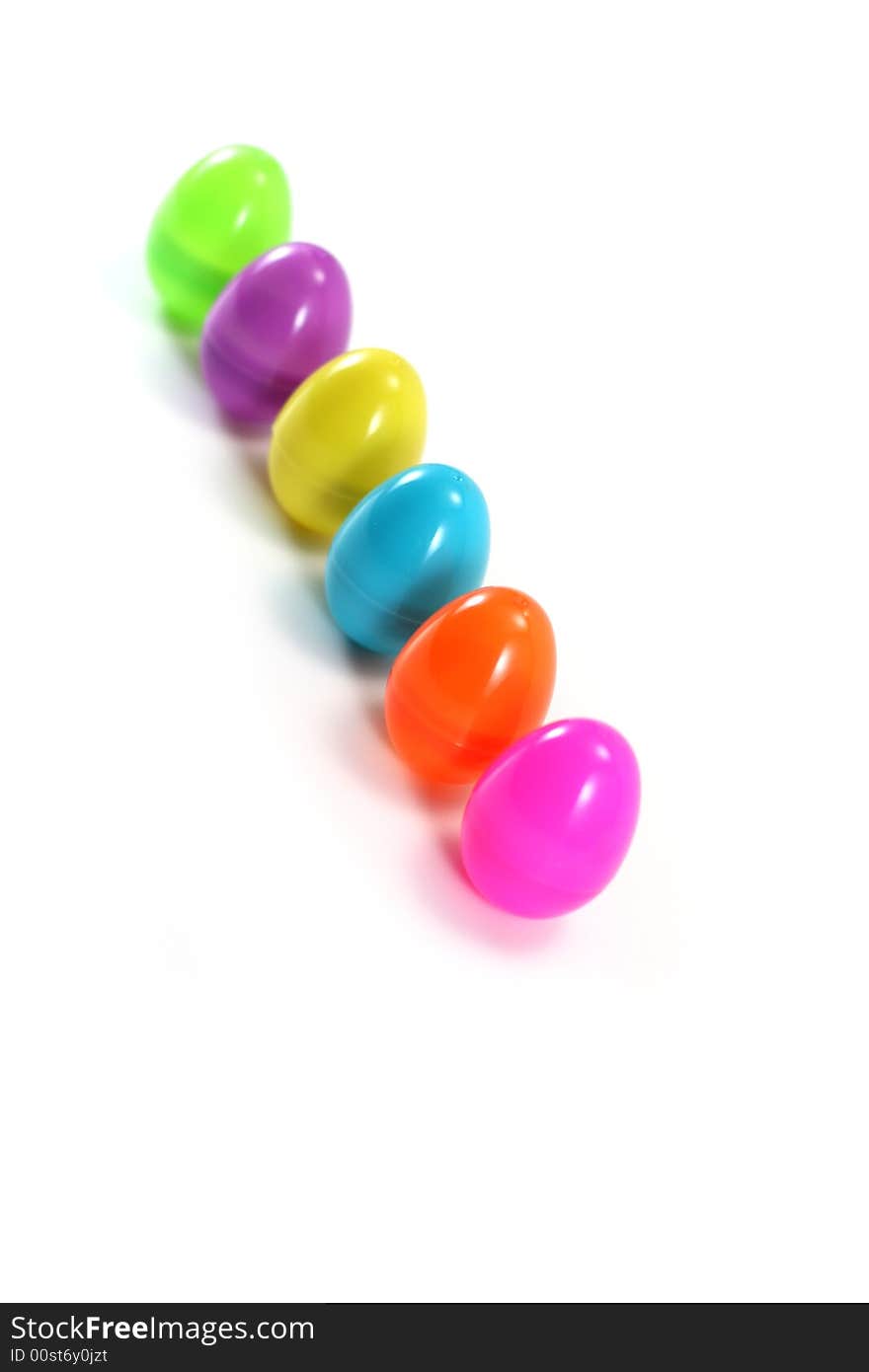 A line of pastel Easter eggs on white background