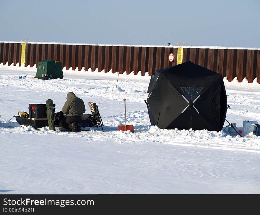 Ice fishing on Michigan lake.