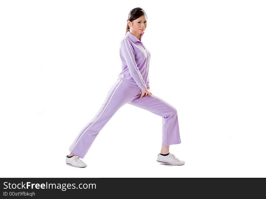 Woman doing exercise by bending one leg side ways