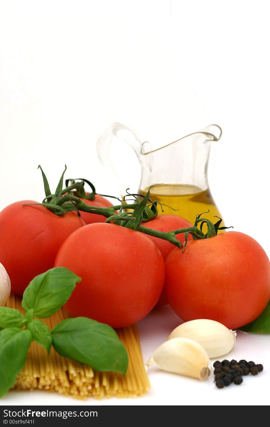 Spaghetti preparation: tomatoes, olive oil, garlic and basil