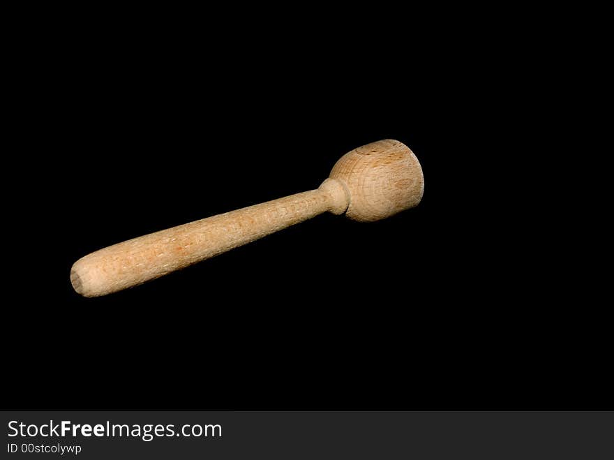 A toy wooden utensil isolated on black.