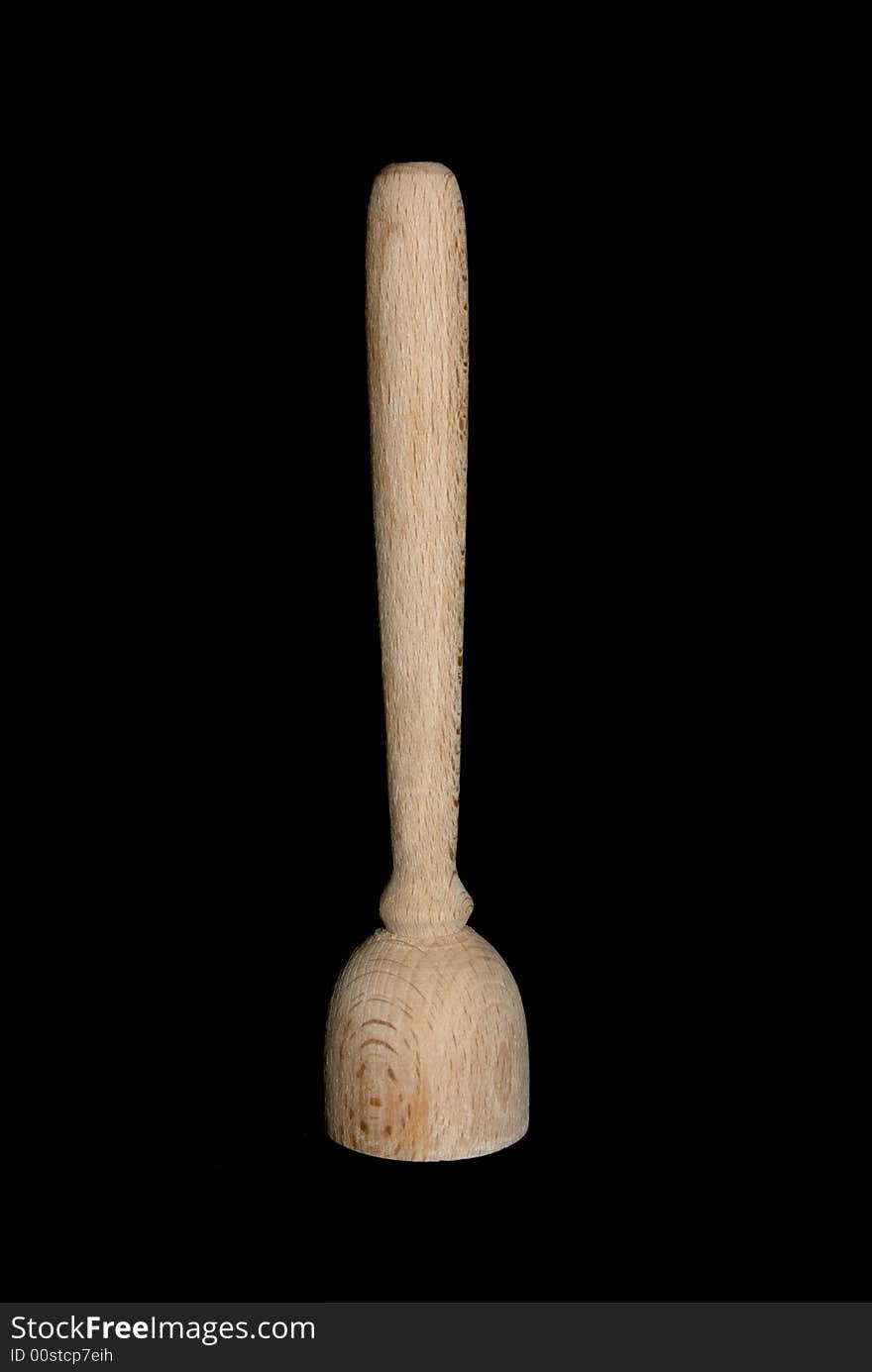 A toy wooden utensil isolated on black.