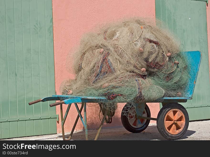 Fishing net to fish posed on the quay