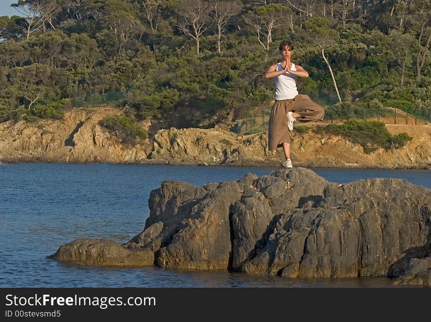 Woman making of yoga at the seaside. Woman making of yoga at the seaside