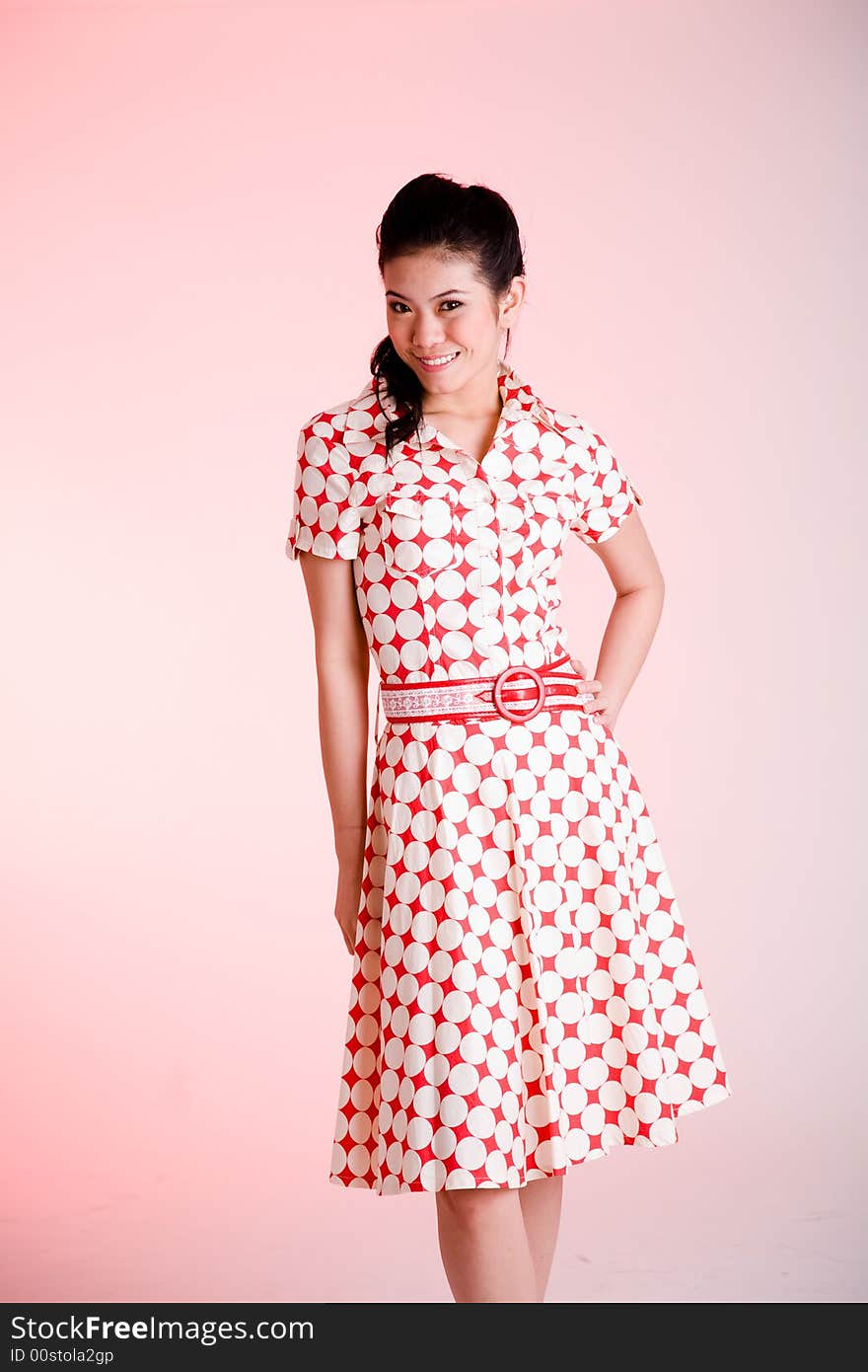 Girl in a red dress with white dots with an expressive face and gesture. Girl in a red dress with white dots with an expressive face and gesture