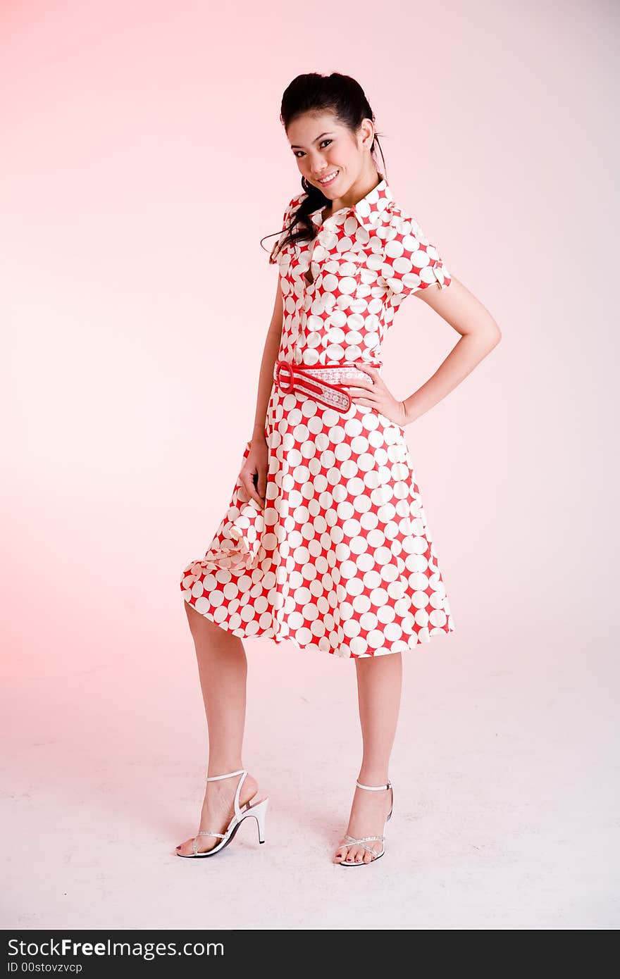 Girl in a red dress with white dots with an expressive face and gesture. Girl in a red dress with white dots with an expressive face and gesture