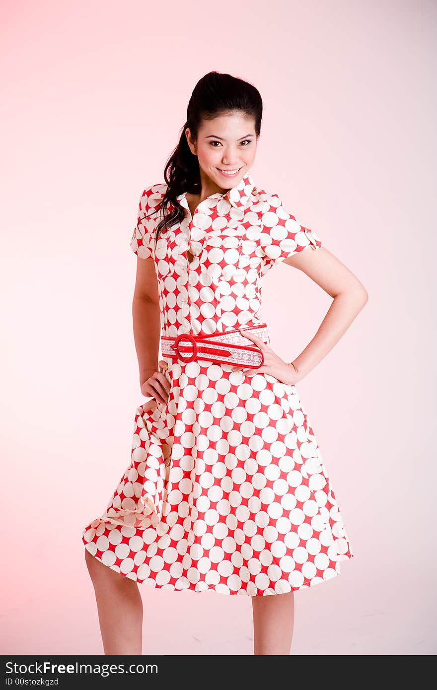 Girl in a red dress with white dots with an expressive face and gesture. Girl in a red dress with white dots with an expressive face and gesture