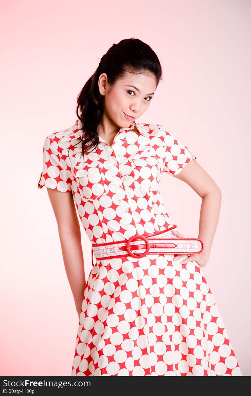 Girl in a red dress with white dots with an expressive face and gesture. Girl in a red dress with white dots with an expressive face and gesture