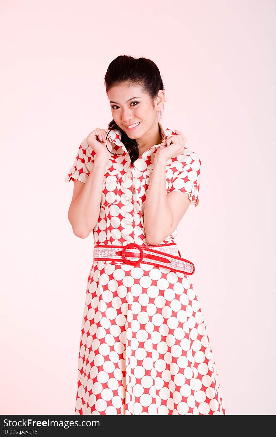 Girl in a red dress with white dots with an expressive face and gesture. Girl in a red dress with white dots with an expressive face and gesture